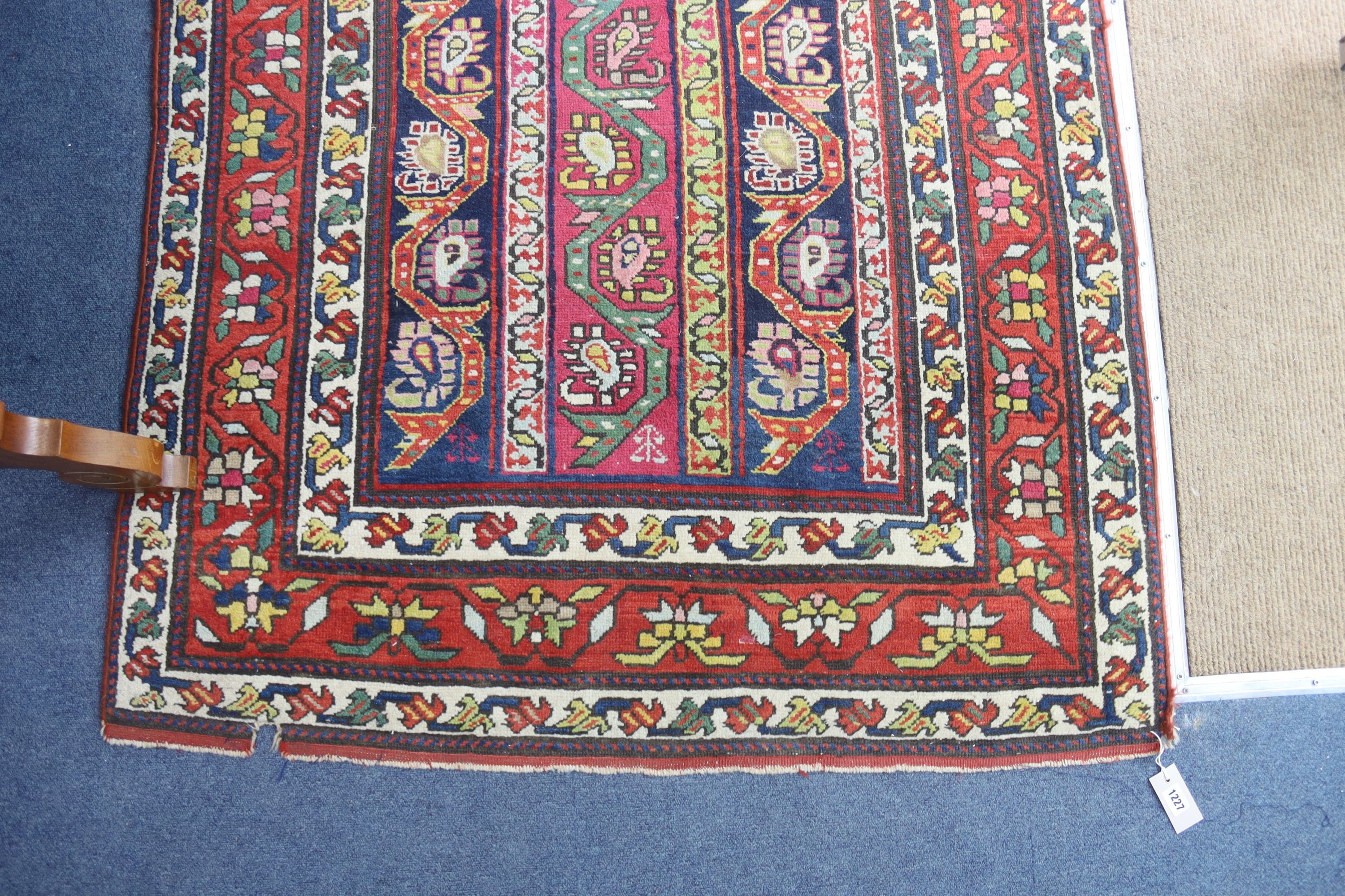 A Caucasian design Boteh red ground rug, 236 x 116cm